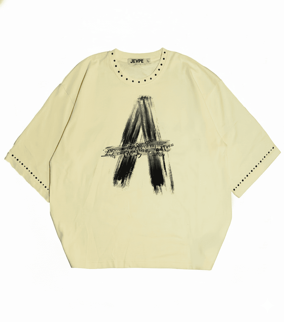 Cream beige JEVPE oversized streetwear T-shirt with brushstroke letter A rivet design, relaxed fit, casual style.