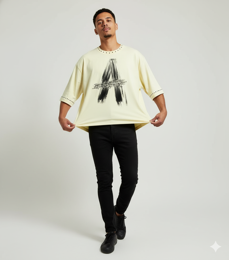 Cream beige oversized streetwear T-shirt by JEVPE featuring a brushstroke letter A and rivet details.