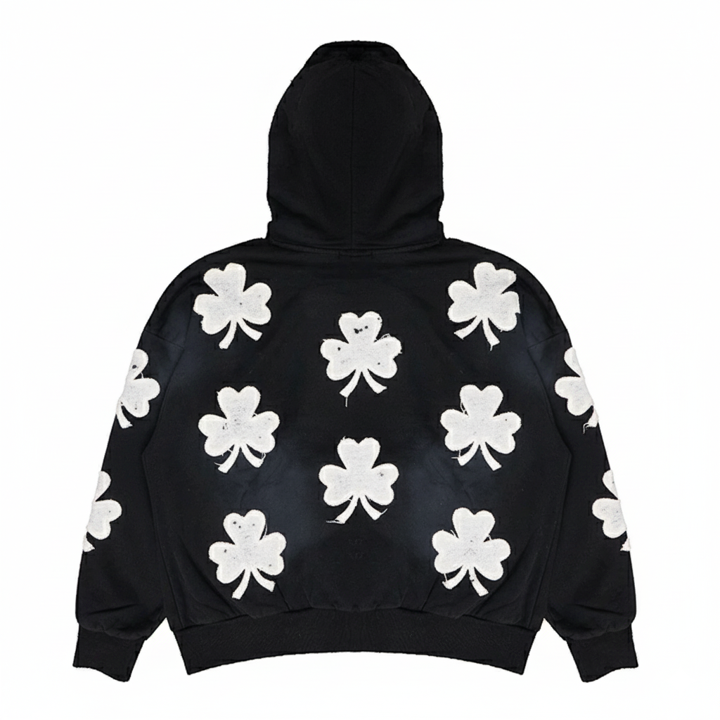Black oversized hoodie for men by JEVPE, featuring vintage streetwear style with bold black Clover graphic on the front.