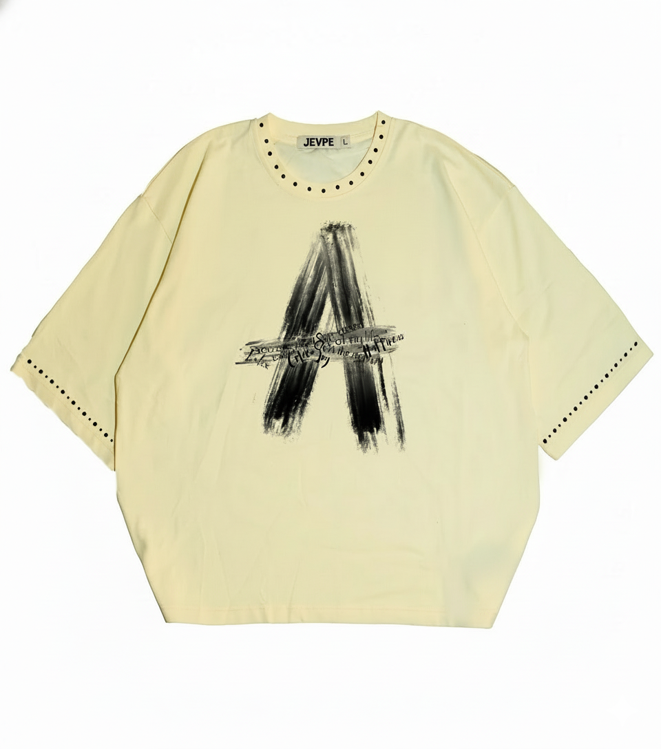 Cream beige JEVPE oversized streetwear T-shirt with brushstroke letter A rivet design, relaxed fit, casual style.
